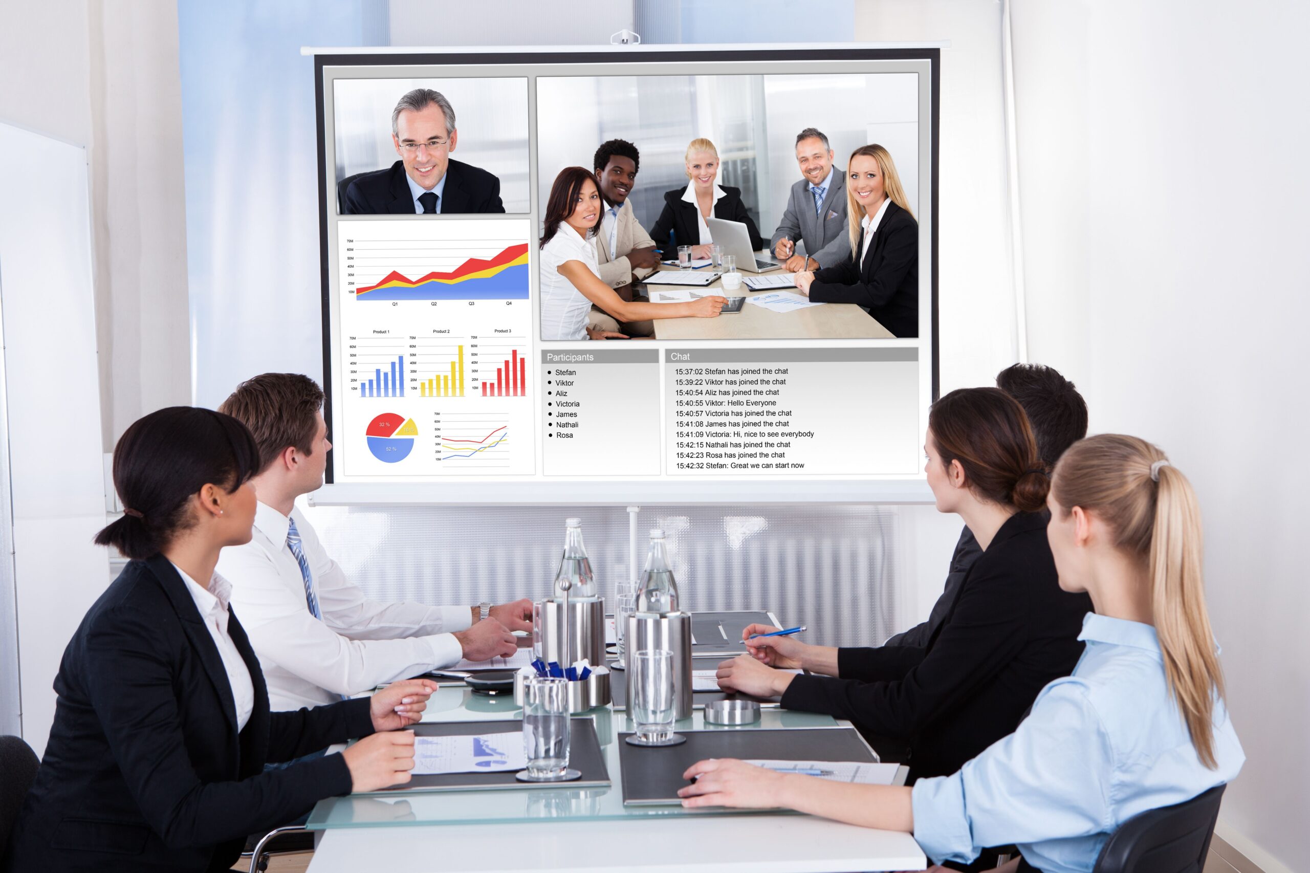 Diverse group of business professionals engaged in discussion around a conference table in a meeting room